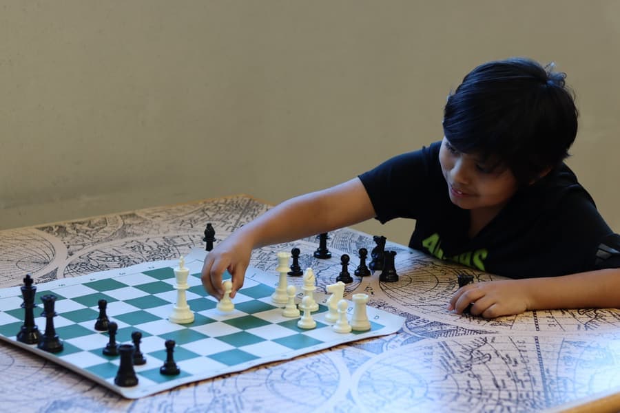 A student studying the chessboard mid-game