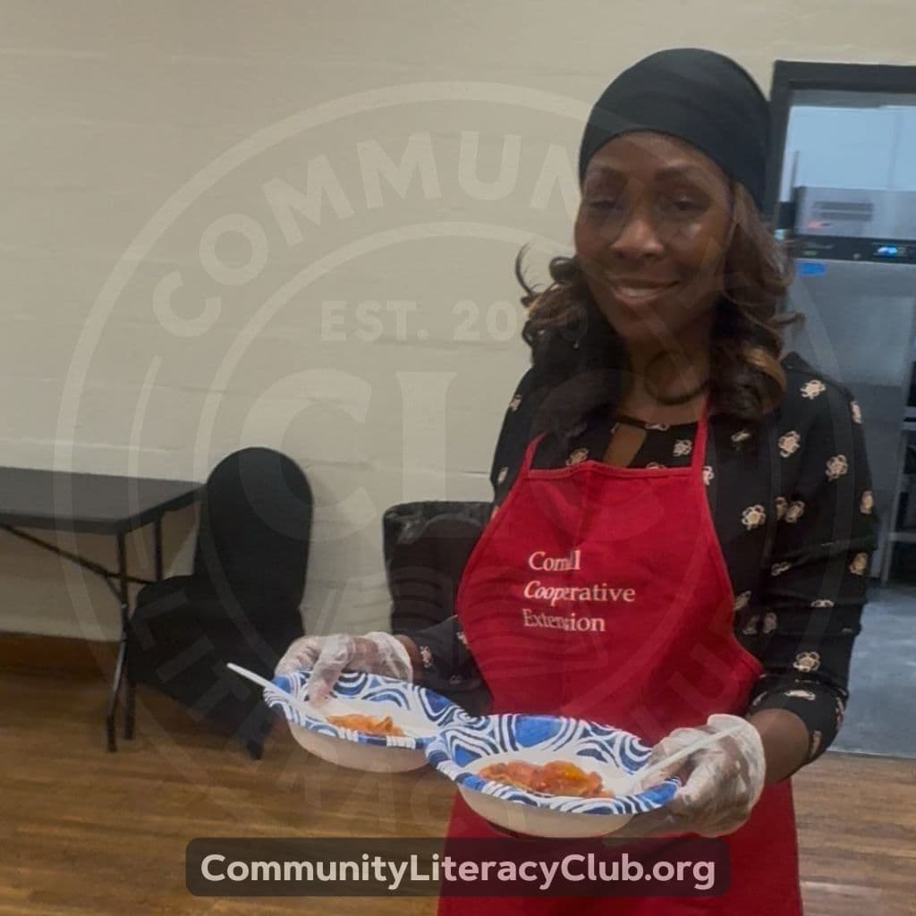 A volunteer in an apron serving healthy food at a community health event