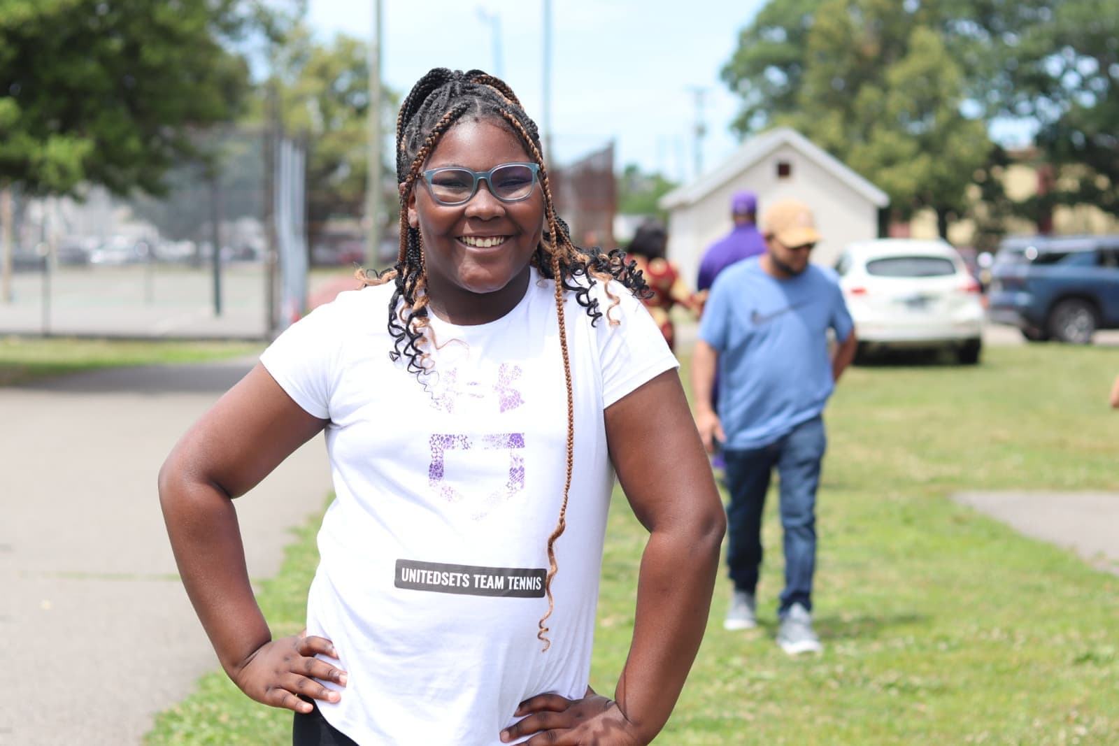 A player all smiles at the outdoor summer courts